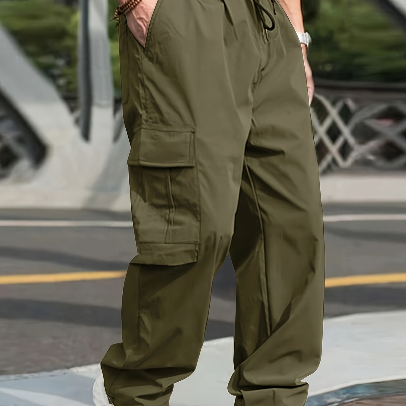 Men's olive green cargo pants with side pockets, adjustable waist, and lightweight twill fabric - perfect for casual street style jogging in all seasons.