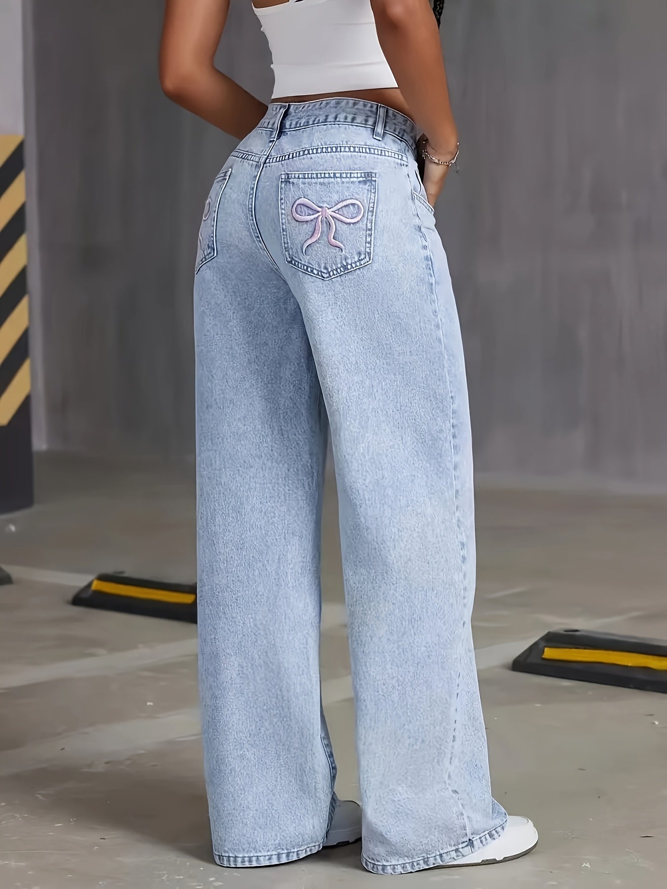 High-rise light wash blue denim wide-leg pants with butterfly details - street style, non-stretch fabric, machine washable.