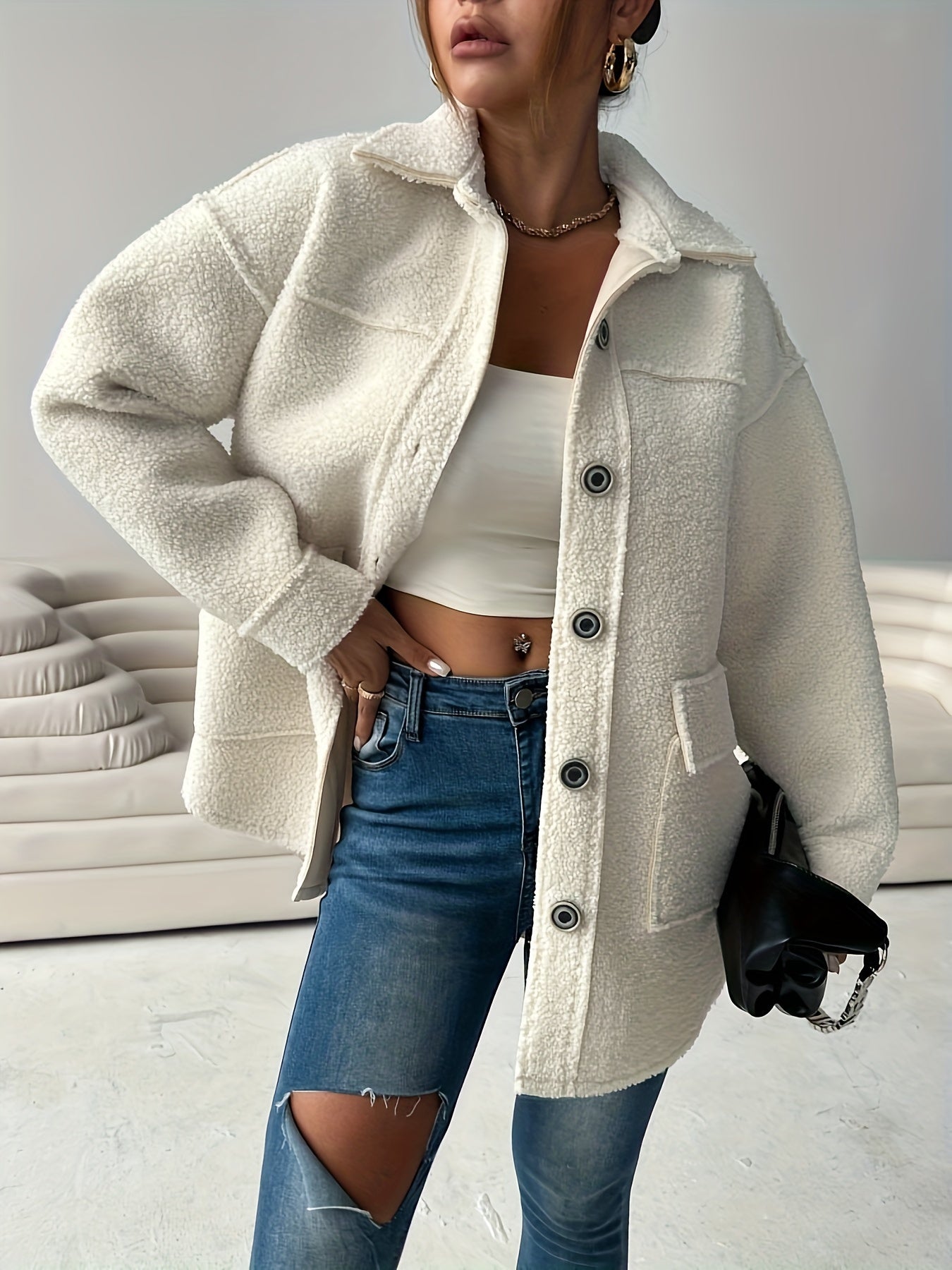 Women's casual teddy jacket made of solid color polyester knit fabric with lapel collar and button details, perfect for fall/winter.