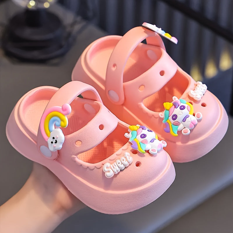 Girls' cartoon clogs in pink and white with charms, suitable for all seasons, indoor/outdoor use.