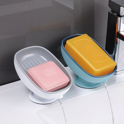 Suction cup soap dish with drainage for bathroom and kitchen sink storage.