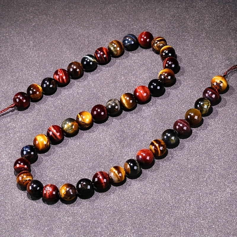 Loose round beads made from natural three-color Tiger Eye stone available for wholesale. Perfect for creating semi-finished DIY jewelry such as woven bracelets, necklaces, and sweater chains.