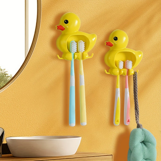 Wall-mounted toothbrush holder with cute duck design, waterproof plastic organizer with suction cup, no-drill installation, home decor.