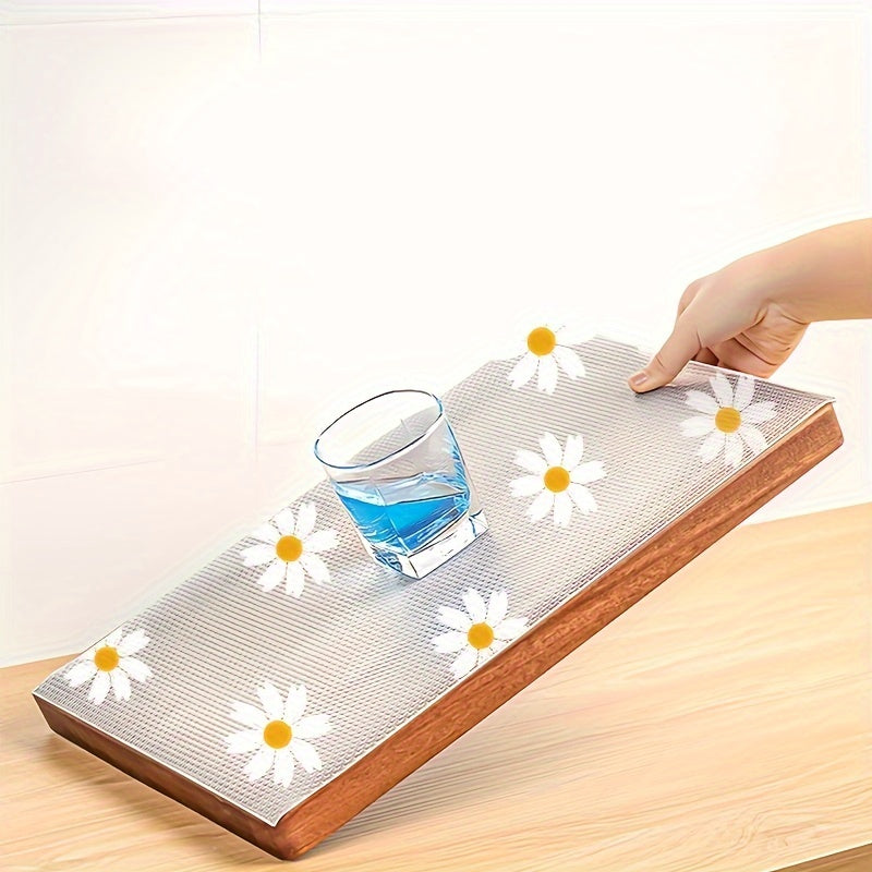 Waterproof Non-Slip Shelf Liner Roll - Plastic, featuring a Daisy Pattern. This Dustproof Drawer Mat is designed for use in Kitchen Cabinets, Refrigerators, and as a Table Pad. It is Moisture-Proof and perfect for use as a Household Liner.