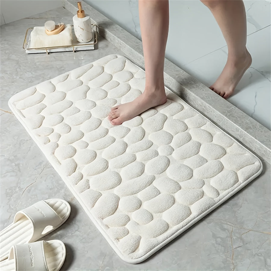 One piece of bath mat with embossed pebble pattern, highly absorbent and non-slip for bathroom use. Suitable for tub, toilet, and floor, made of machine washable polyester material. Dimensions are 59.94x39.88 cm.