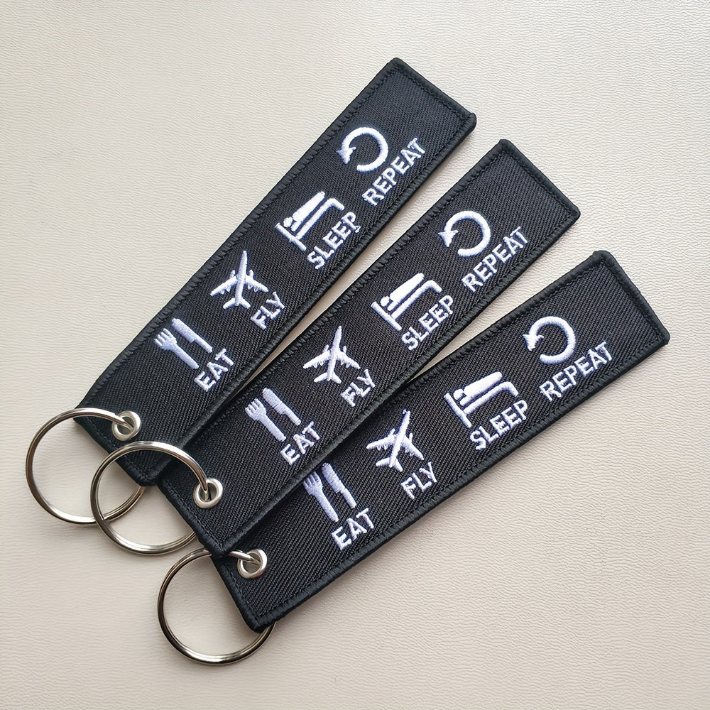 Set of three 'Eat Fly Sleep Repeat' keychains with embroidered design. Ideal gift for pilots, aviation enthusiasts, or anyone with a sense of humor. Keychains come in black and white color combination.