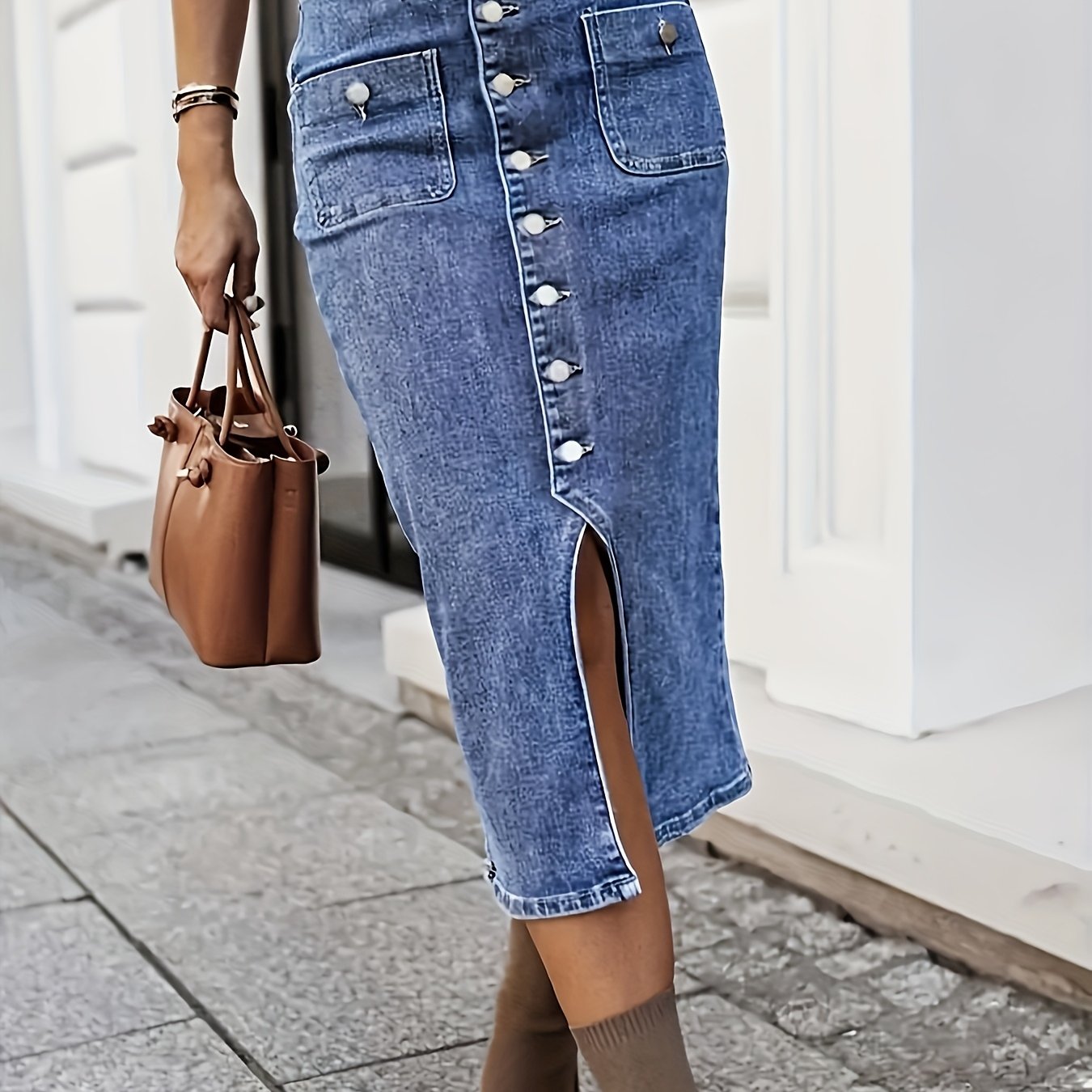 Women's washed blue denim skirt with front buttons, side slit, and casual stretch denim. Ideal for autumn casual outfits.