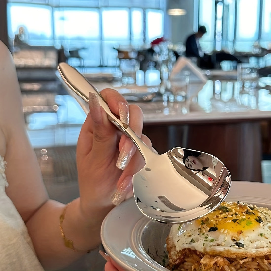 Elegant oversized stainless steel spoon for serving rice, eggs, and more with a shiny, durable finish.