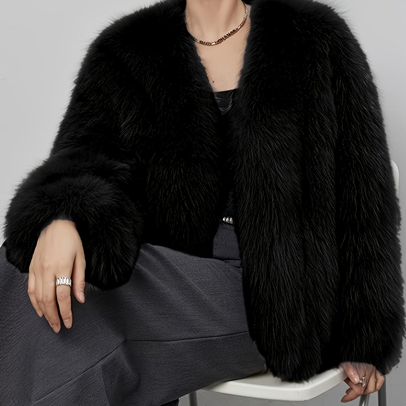 Stylish women's coat in light gray faux fur with fluffy collar, perfect for cold weather