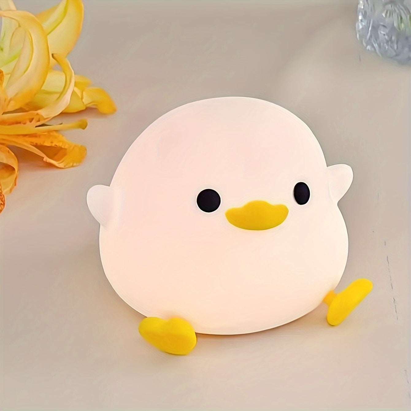 Soft light eye protection silicone night light in the shape of a duck, with 7-color tap light feature. This small table lamp is perfect for use in the bedroom or while breastfeeding. Requires 3 AAA batteries (not included).