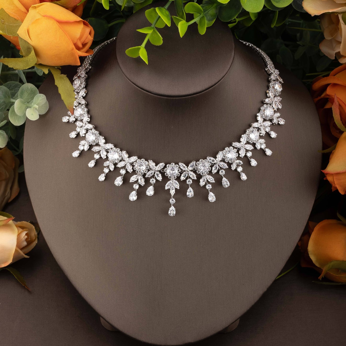 Beautiful wedding jewelry ensemble featuring intricate floral design with dazzling cubic zirconia stones, crafted in luxurious 18K gold plated copper. This set includes a necklace, earrings, bracelet, and ring, perfect for both bridal wear and special