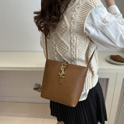 Elegant women's crossbody bucket bag with vintage style, adjustable strap, zipper closure, polyester lined. Available in black, white, dark brown, light brown. Suitable for work, commute