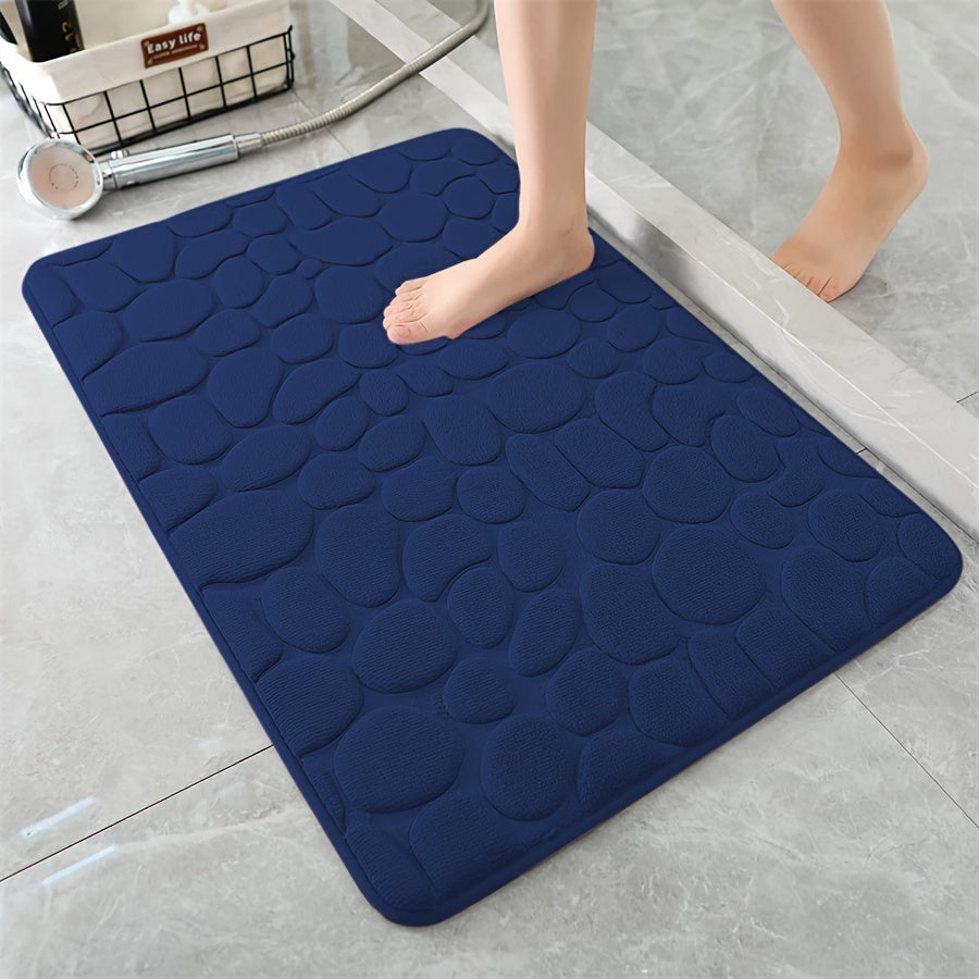 One piece of bath mat with embossed pebble pattern, highly absorbent and non-slip for bathroom use. Suitable for tub, toilet, and floor, made of machine washable polyester material. Dimensions are 59.94x39.88 cm.