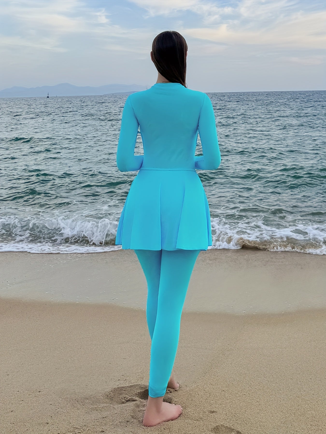 Sporty one-piece swimsuit with full coverage, long sleeves, high-waist skirt, and slimming design.