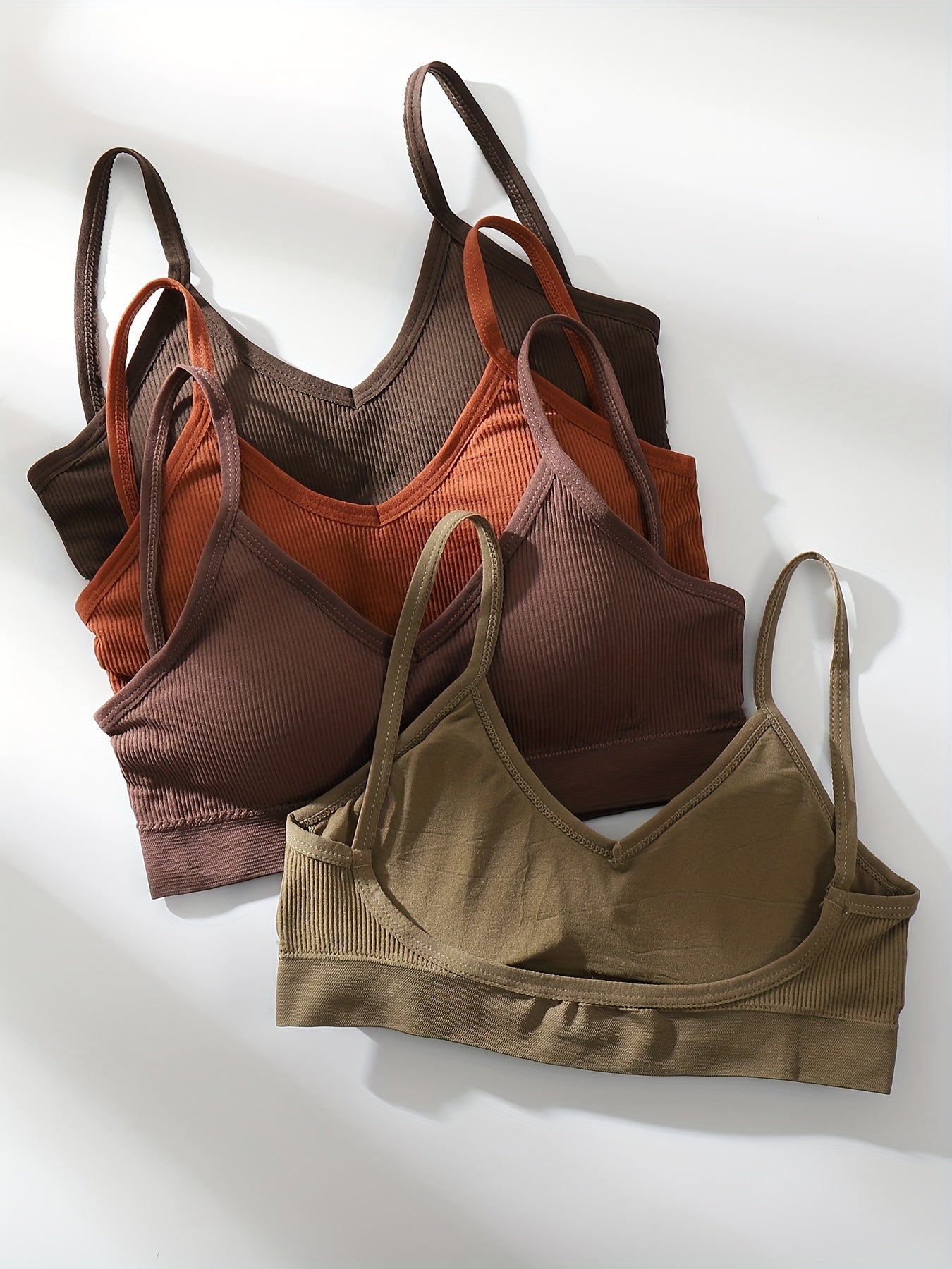 Four wireless bras made of solid ribbed material that are comfortable, breathable, and stretchy. Ideal for women looking for lingerie and underwear.