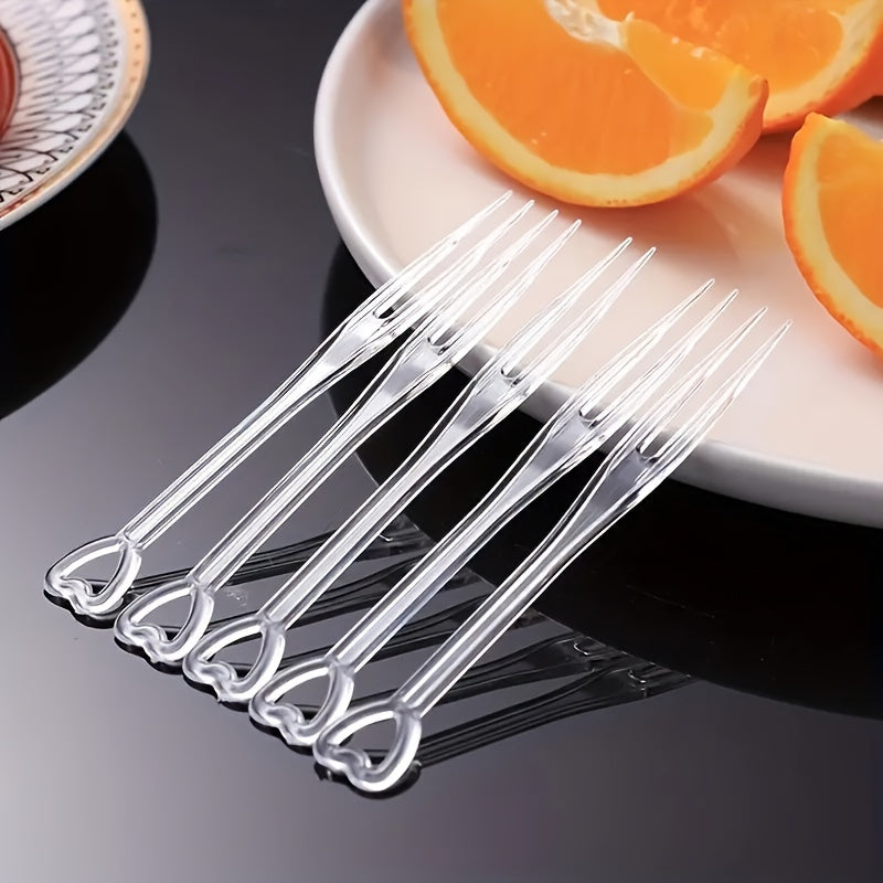 Pack of 200 Disposable Fruit Forks - Ideal for Home, Kitchen, Restaurant, Picnic, Camping, and Parties. Heart-shaped design, perfect for desserts. Made from durable plastic. Essential tableware accessory for any event.