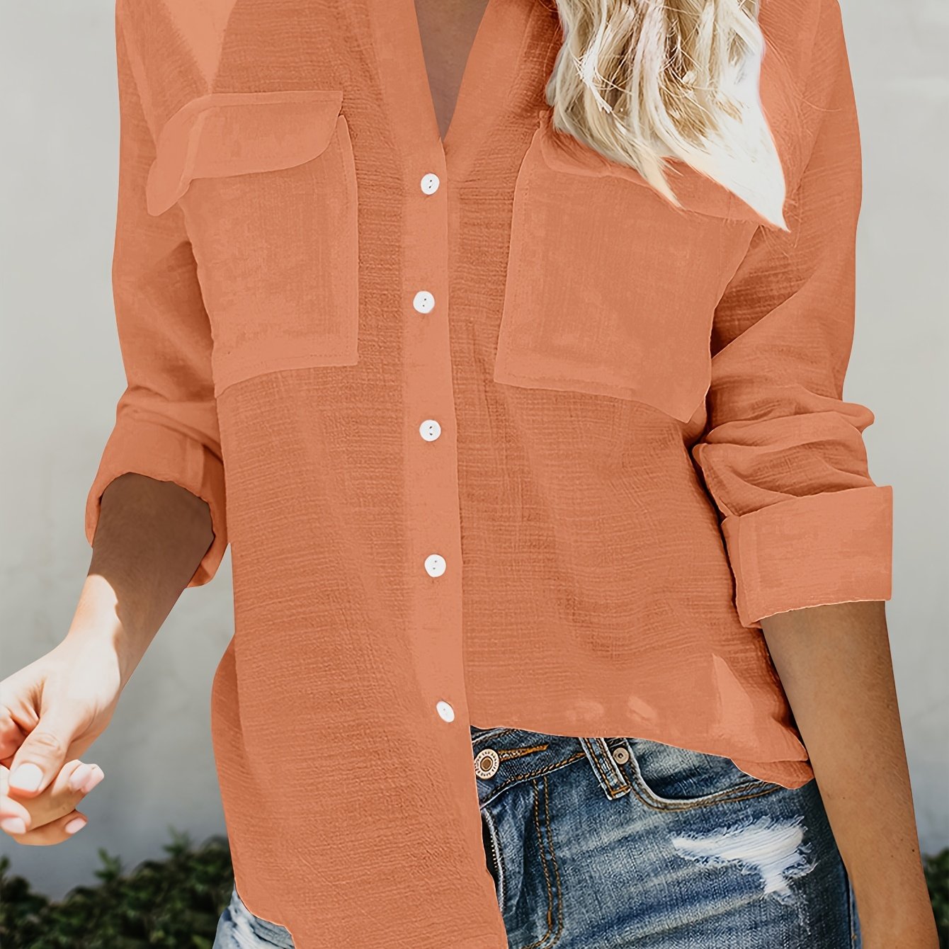 Women's elegant orange blouse with V-neck, button front, and rolled cuffs. Casual fit for work or leisure in breathable fabric, perfect for spring/fall.