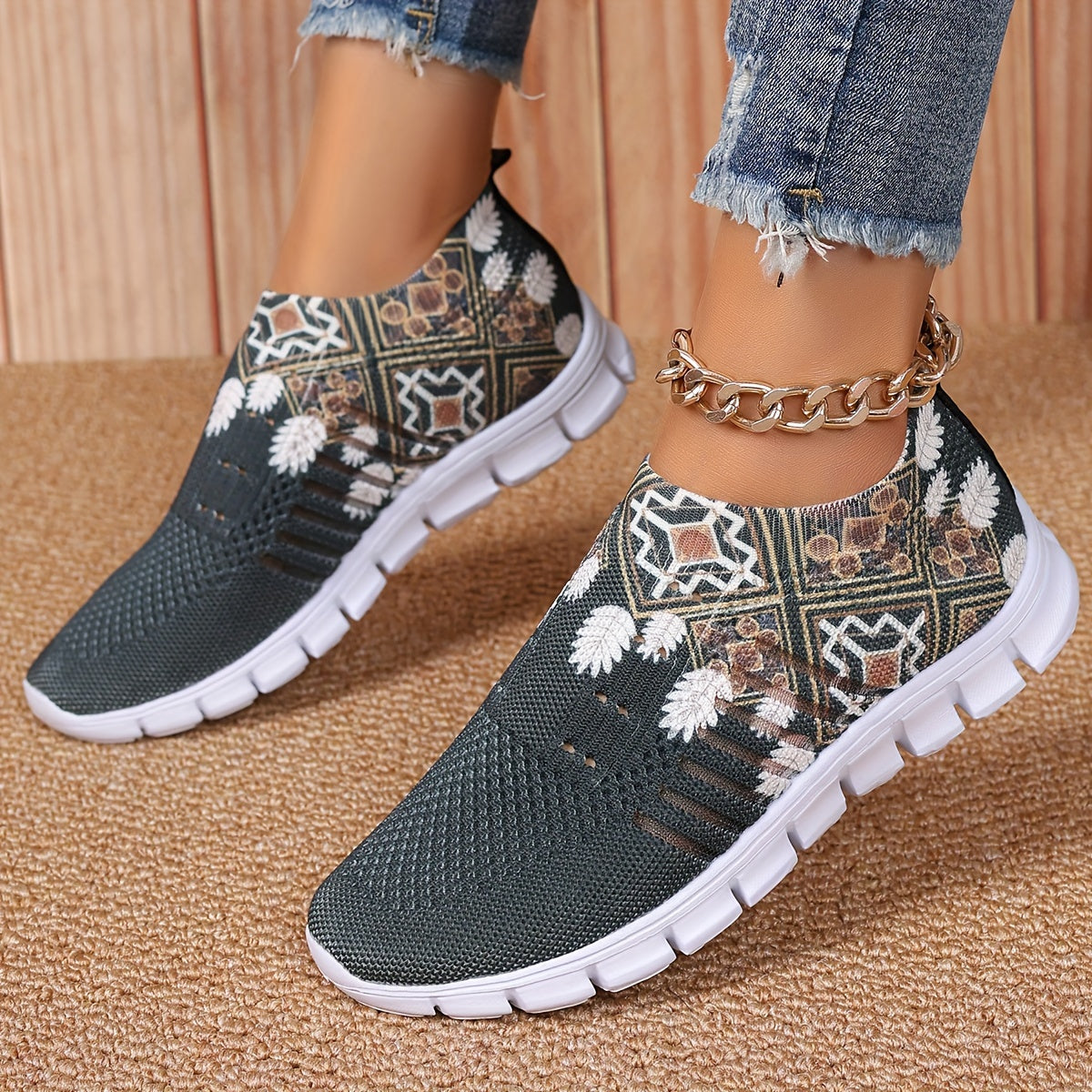 Women's casual slip-on sneakers in blue knit fabric with white floral and geometric patterns, featuring a lightweight EVA sole and breathable low-top design. Perfect for everyday wear with