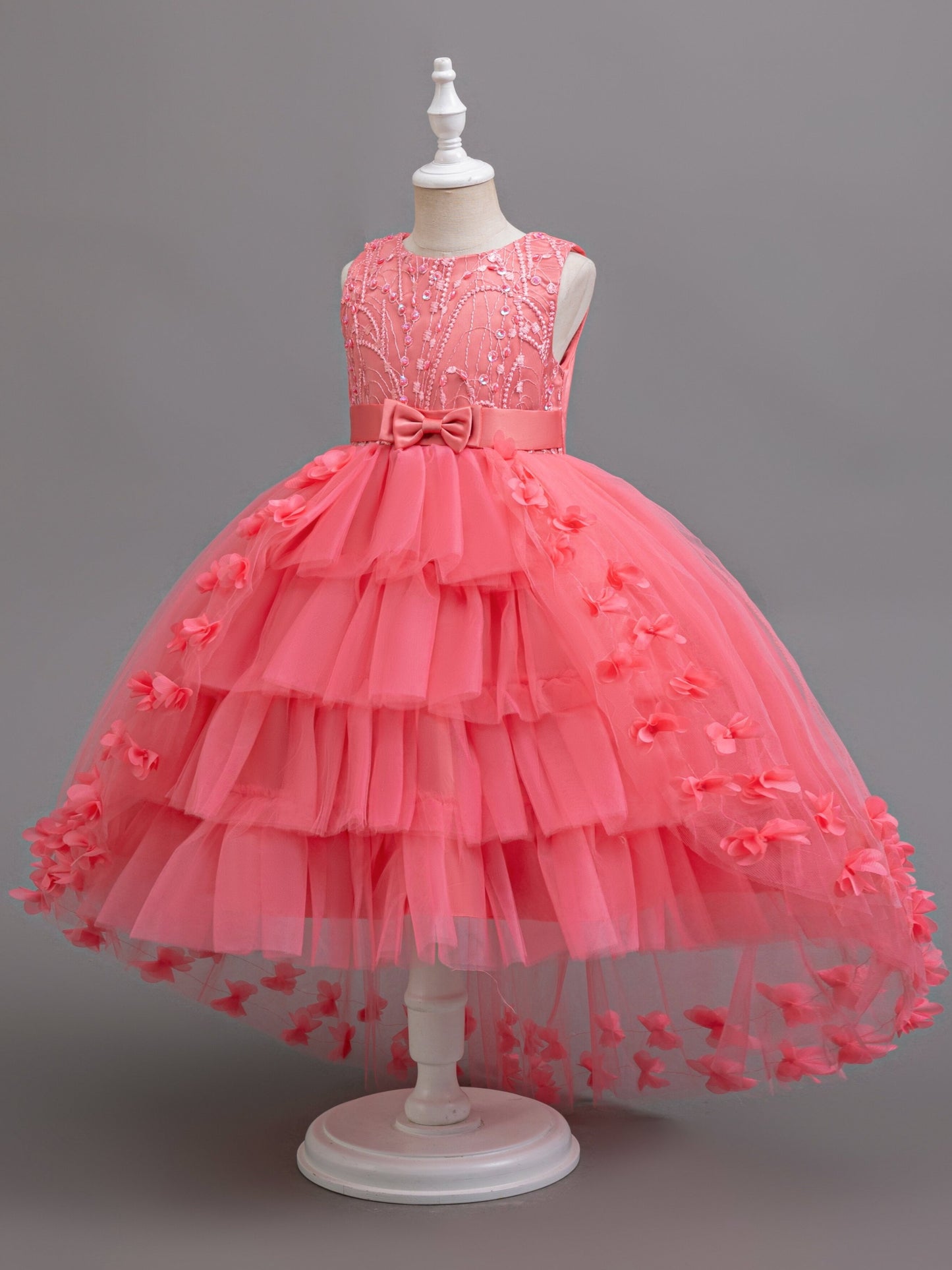 Elegant sleeveless dress with tiered mesh tutu, fake pearls, bowknot, and floral design for parties and balls.