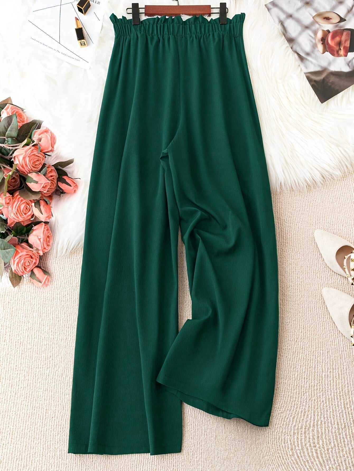 Flowy green polyester wide-leg pants with a tie waist, high-rise fit, and smooth fabric. Suitable for casual or office wear in spring/summer/fall. Machine washable.