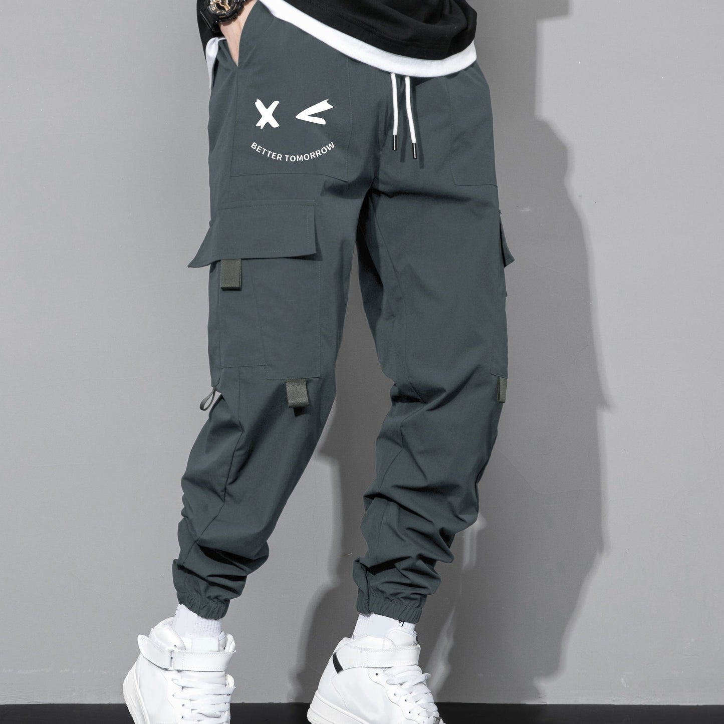 Stylish cargo pants with multiple pockets for men, featuring a loose fit and drawstring waistband for a casual outdoor streetwear look.