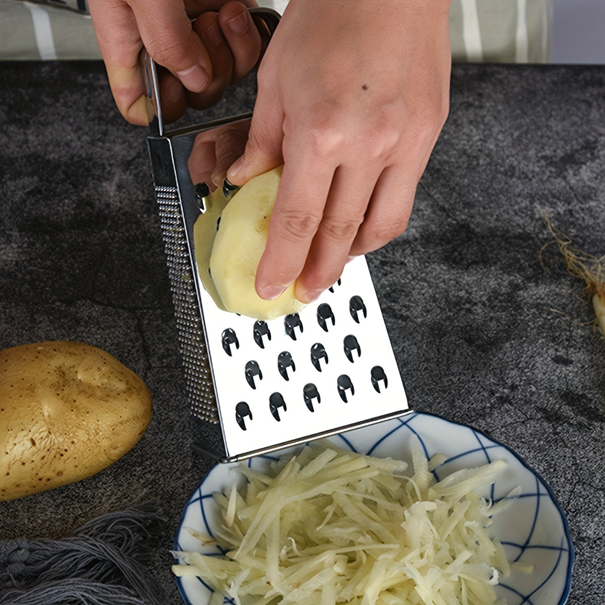 Upgrade your kitchen with the Stainless Steel 4-Sided Box Grater - a versatile tool for grating cheese, vegetables, and potatoes. This multifunctional grater features a non-slip handle for easy use.