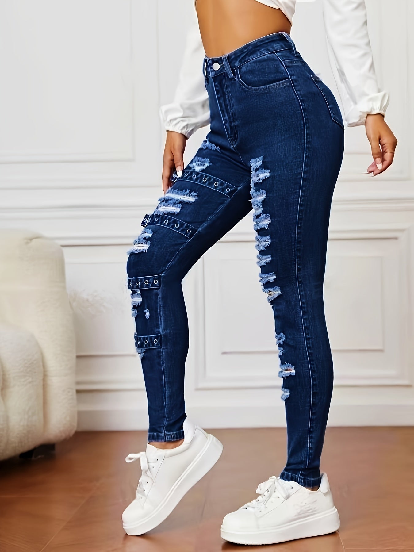 High-waisted stretchy jeans with rip and repair details for women, cotton/polyester blend, machine washable, suitable for all seasons.