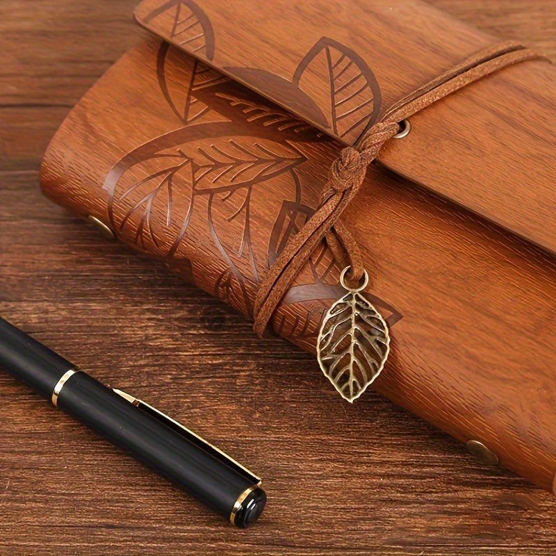 Vintage spiral-bound faux leather notebook with leaf-embossed design and strap closure, available in black, orange, and blue, perfect for students and travelers.