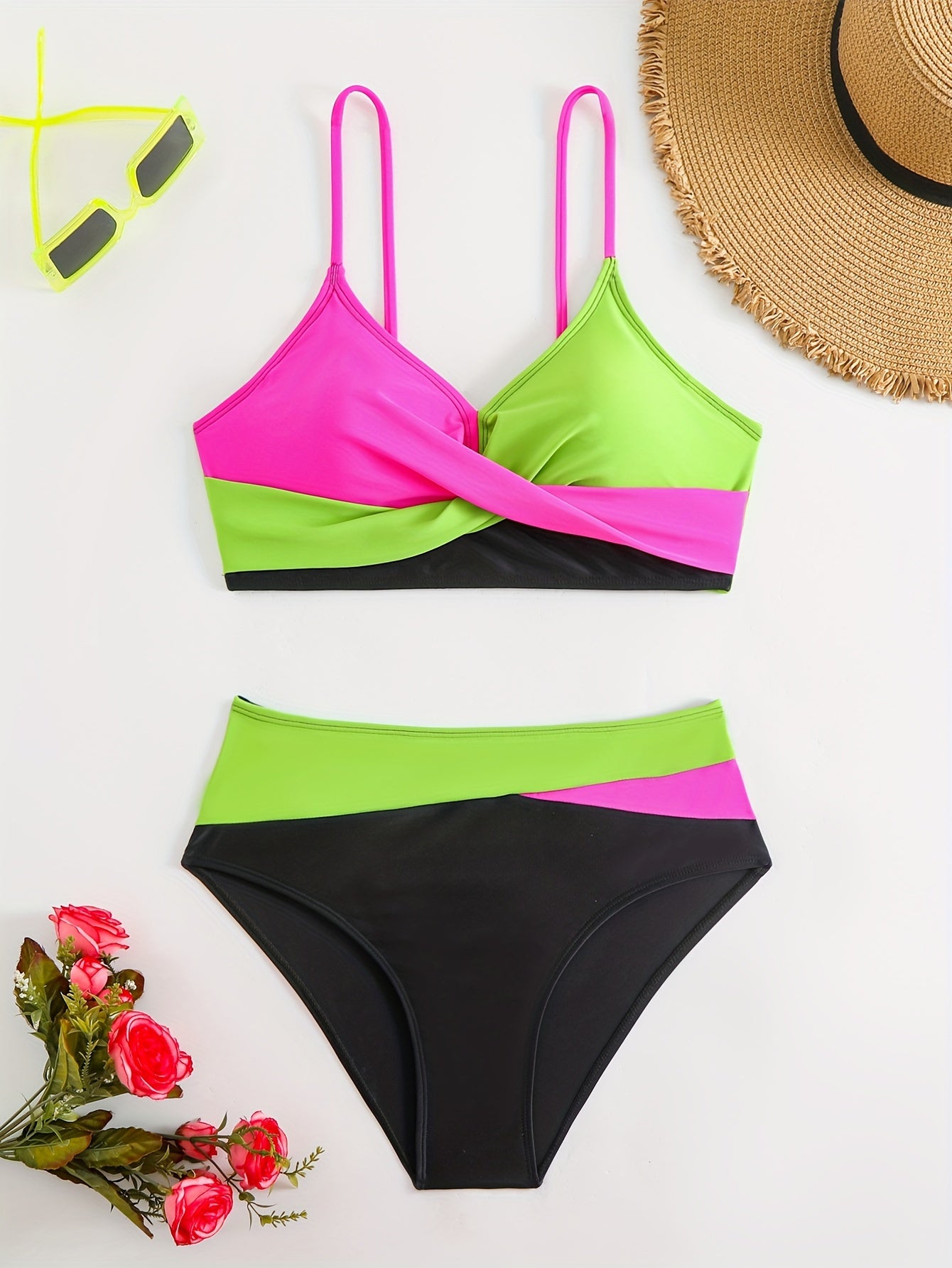 Patchwork two-piece swimsuit with crossed colors and high-waisted design.