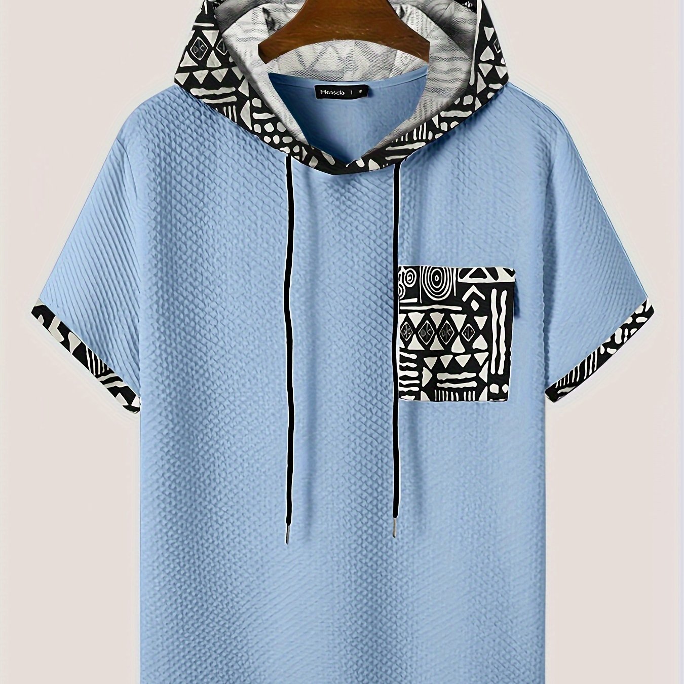 Men's plus size casual hooded t-shirt with geometric print, made from lightweight polyester fabric in gray with black and white patterns. Includes drawstring hood for comfortable fit and