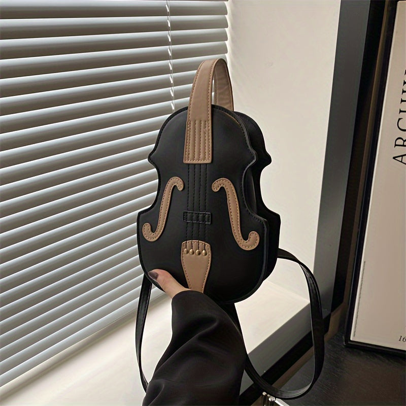 Stylish black/white violin-shaped crossbody bag with adjustable strap, perfect for casual use.