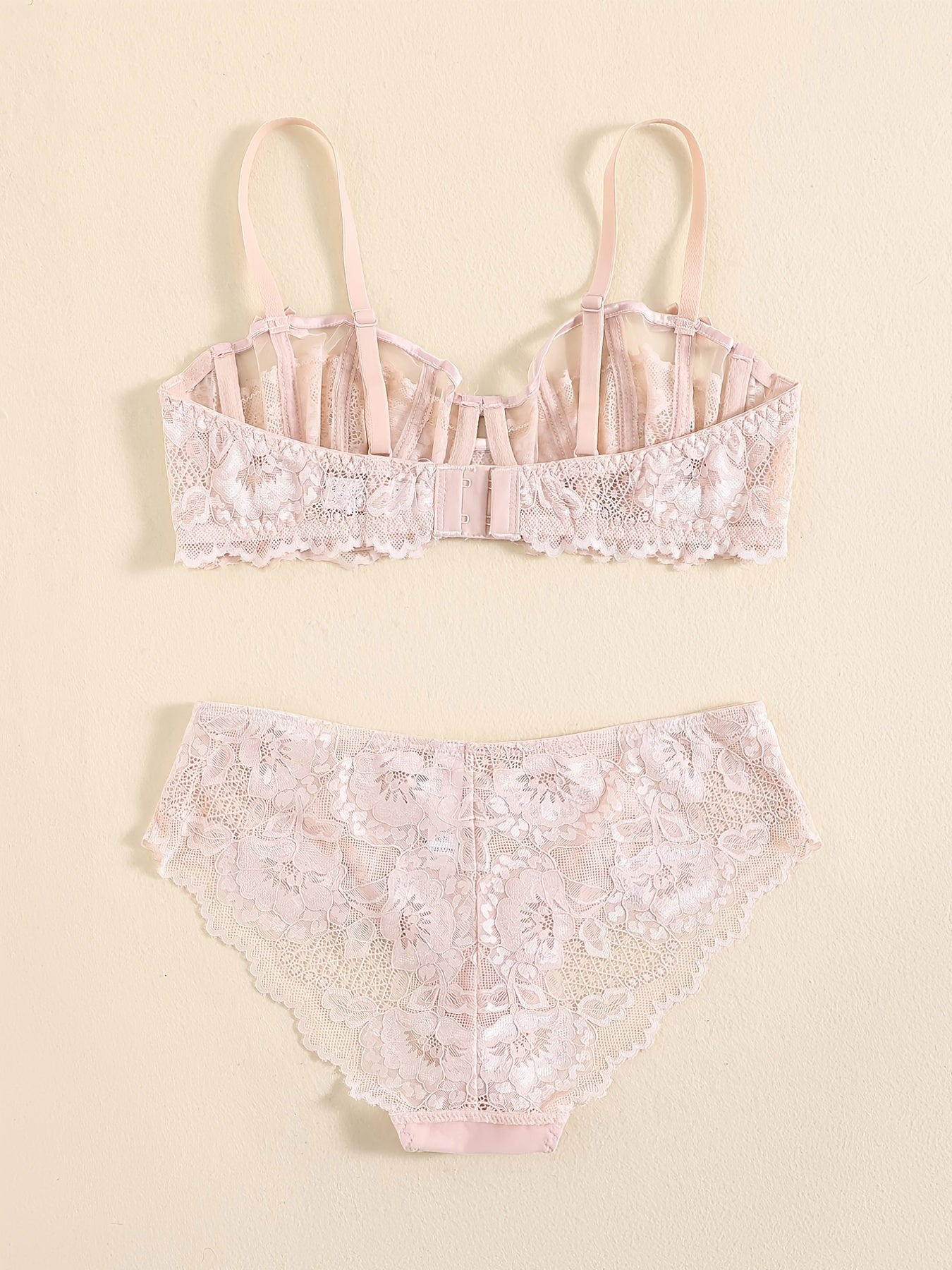 Floral lace unlined bra and bow panties set for women.