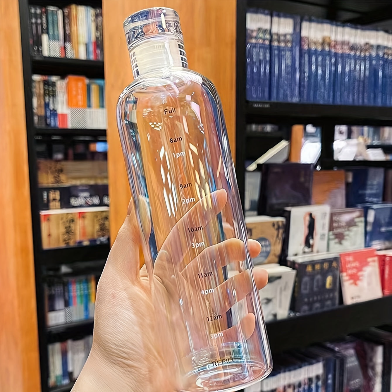 Reusable round plastic water bottle with time markers, ideal for various uses like office, school, and home, suitable for juice and iced drinks, hand wash only, and made of recyclable material.