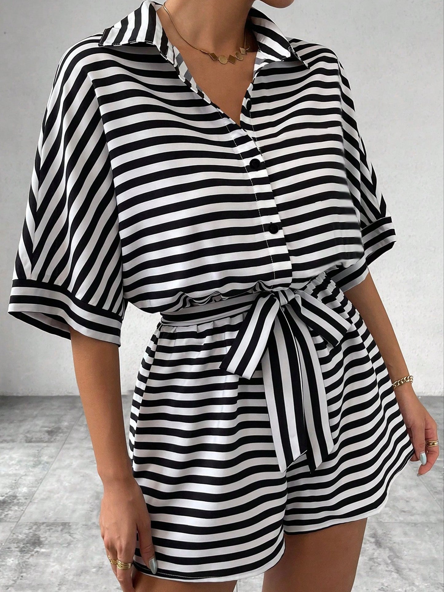 Button front romper jumpsuit with stripes, belt, short sleeves for spring and summer.