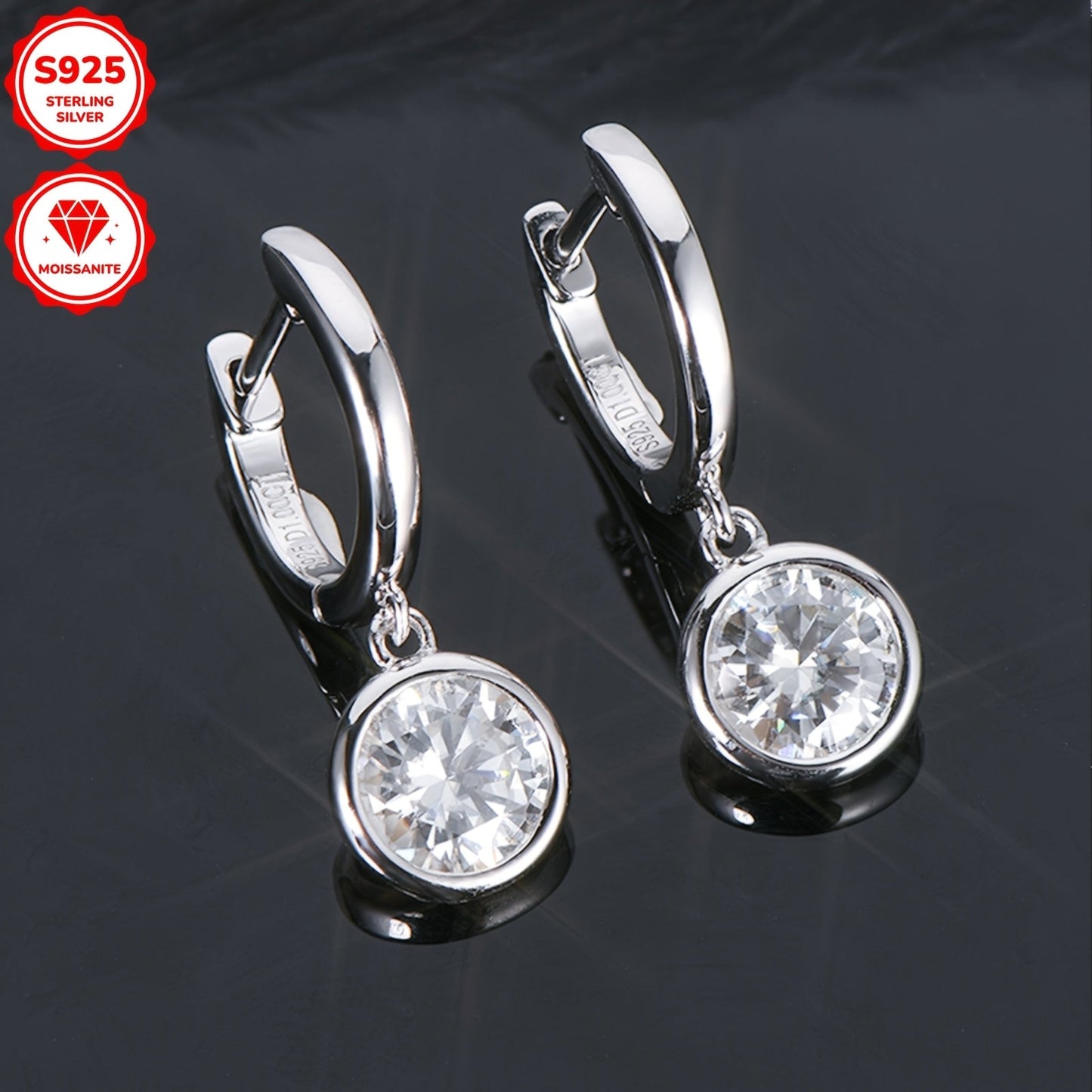 Pair of elegant Moissanite earrings with a silvery gram weight of 2.52g. Featuring two 6.5mm Moissanite stones totaling 1.0 carat each, set in 925 Sterling Silver. These round Moissanite earrings are perfect for adding a touch of glamour to any outfit