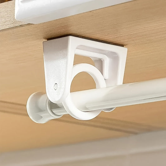 Set of four no-drill curtain rod holders that rotate 360 degrees. These self-adhesive holders are easy to install and can support tension rods for home decor. The holders are in an off white color and can hold rings, hooks, and hangers.