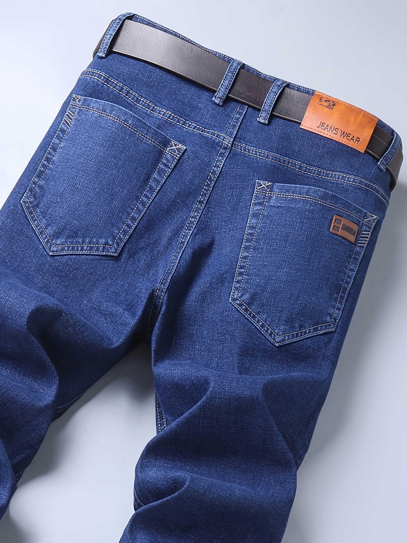 High-quality business casual denim pants for men, featuring a stretch comfort fit in a solid color washed finish. Made with all-season woven fabric of 65% cotton, 33.7% polyester, and 1.3%