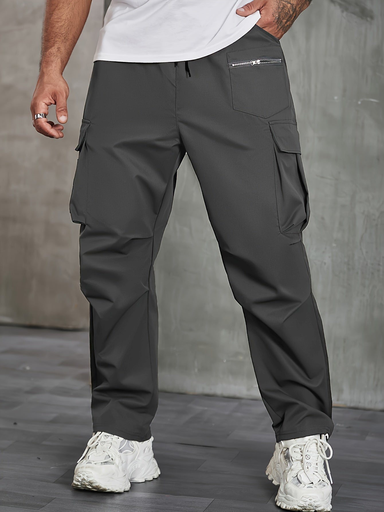 Men's solid cargo pants in plus sizes for spring and fall outdoor sports.