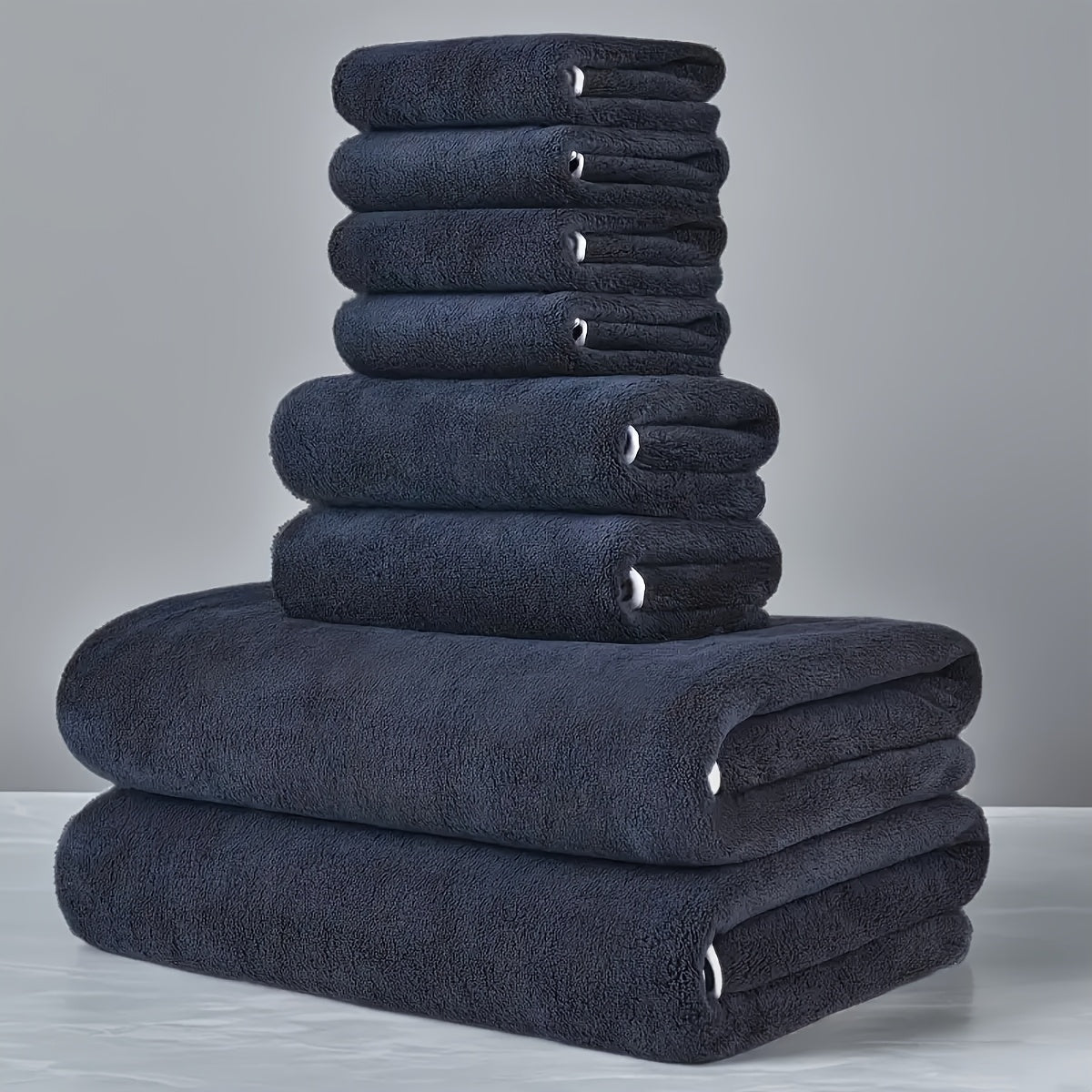 This 8-piece set includes 2 bath towels (68.58 X 139.7 cm), 2 towels (34.8 X 74.93 cm), and 4 square towels (29.97 X 29.97 cm). They are super soft, quick-drying, absorbent, and