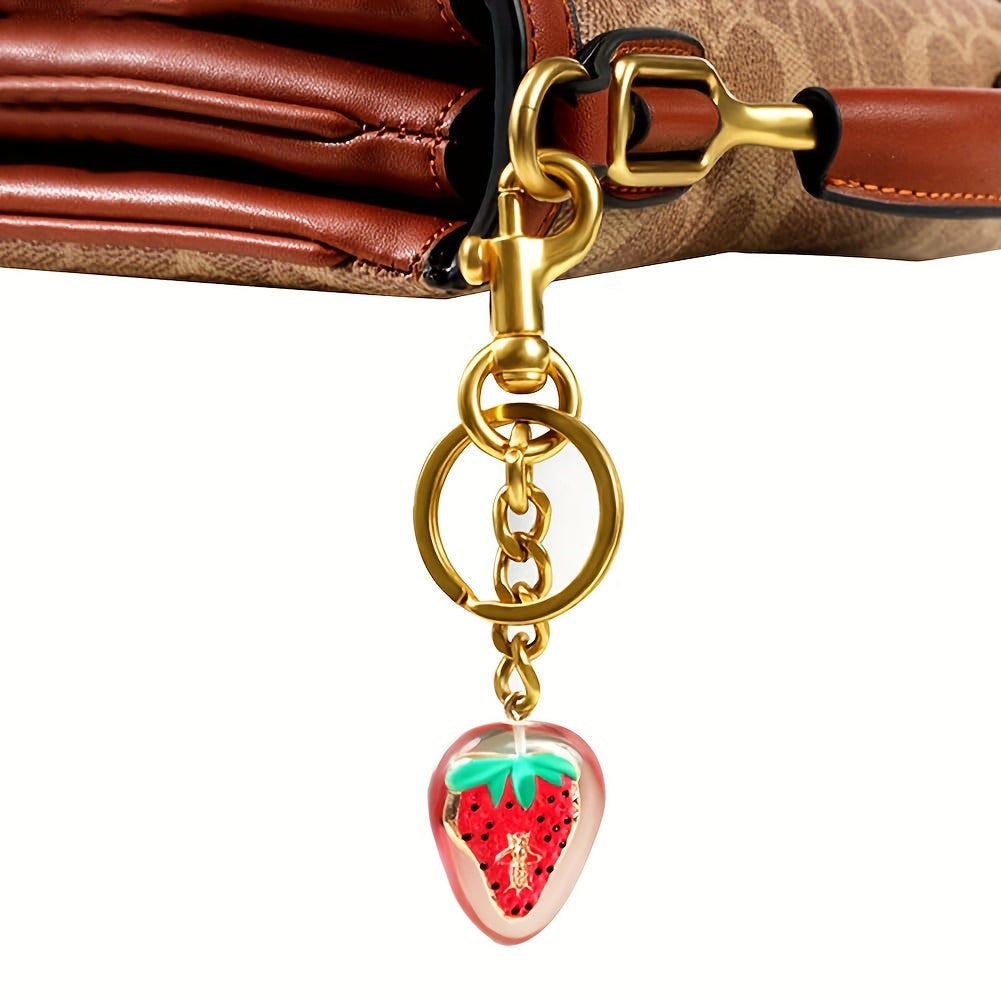 Add a touch of sparkle to your handbag with the TASAHNI Sparkling Cherry Keychain Charm. This stylish resin and metal fashion accessory features a lobster clasp for easy attachment. Perfect as a decorative women's key ring, this single piece is ideal for