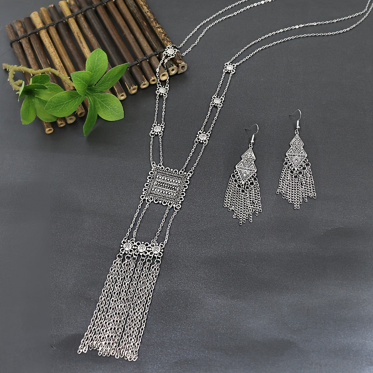 This retro ethnic style women's jewelry set includes three pieces: a geometric zinc alloy necklace and matching tassel long earrings. The set is simple, stylish, and versatile, suitable for all seasons and can be paired with a long skirt or sweater.