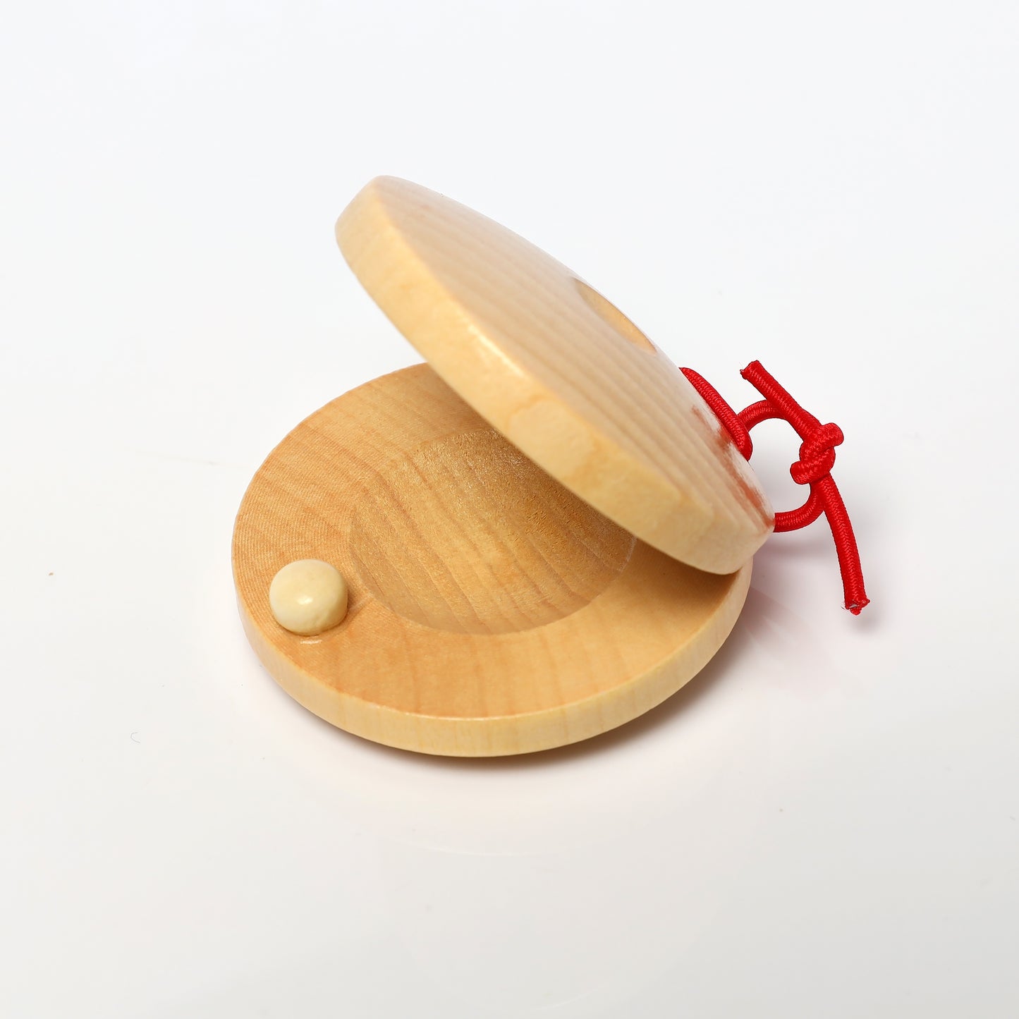 Handcrafted wooden Orff percussion rattle for music practice.