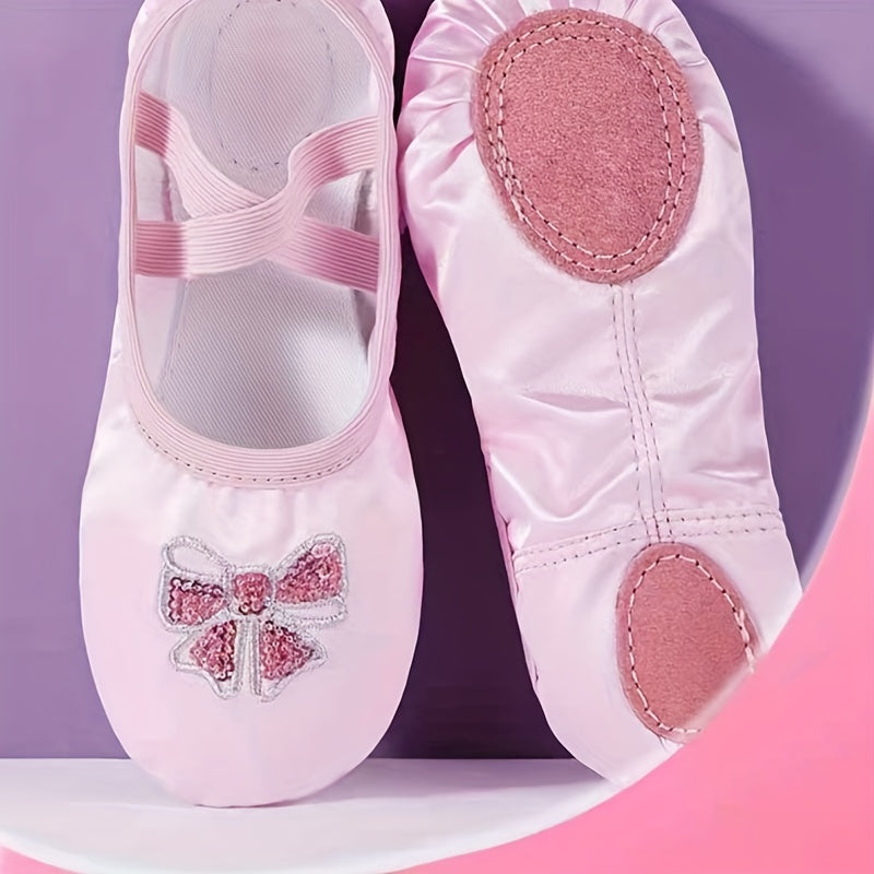 Girls’ ballet dance shoes with sparkling sequin and embroidered bow detail, soft sole, breathable canvas slip-ons. Available in pink and peach.