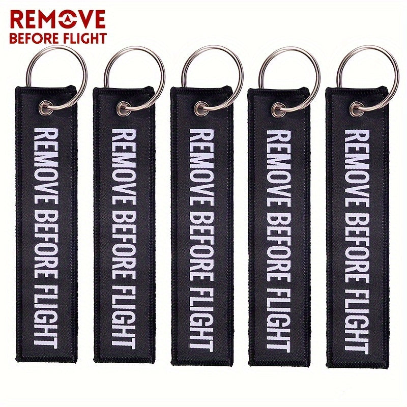 Bundle of 50 'Remove Before Flight' Woven Keychains made from sturdy polyester material - Ideal present for pilots and aviation fans, featuring the iconic phrase "REMOVE BEFORE FLIGHT