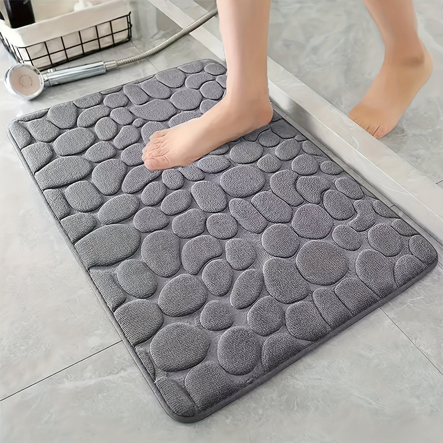 Soft and comfortable memory foam bath rug with cobblestone embossment, designed for rapid water absorption and easy washing. Featuring a non-slip backing, this rug is perfect for use in the shower room and as a stylish bathroom accessory. Ideal for