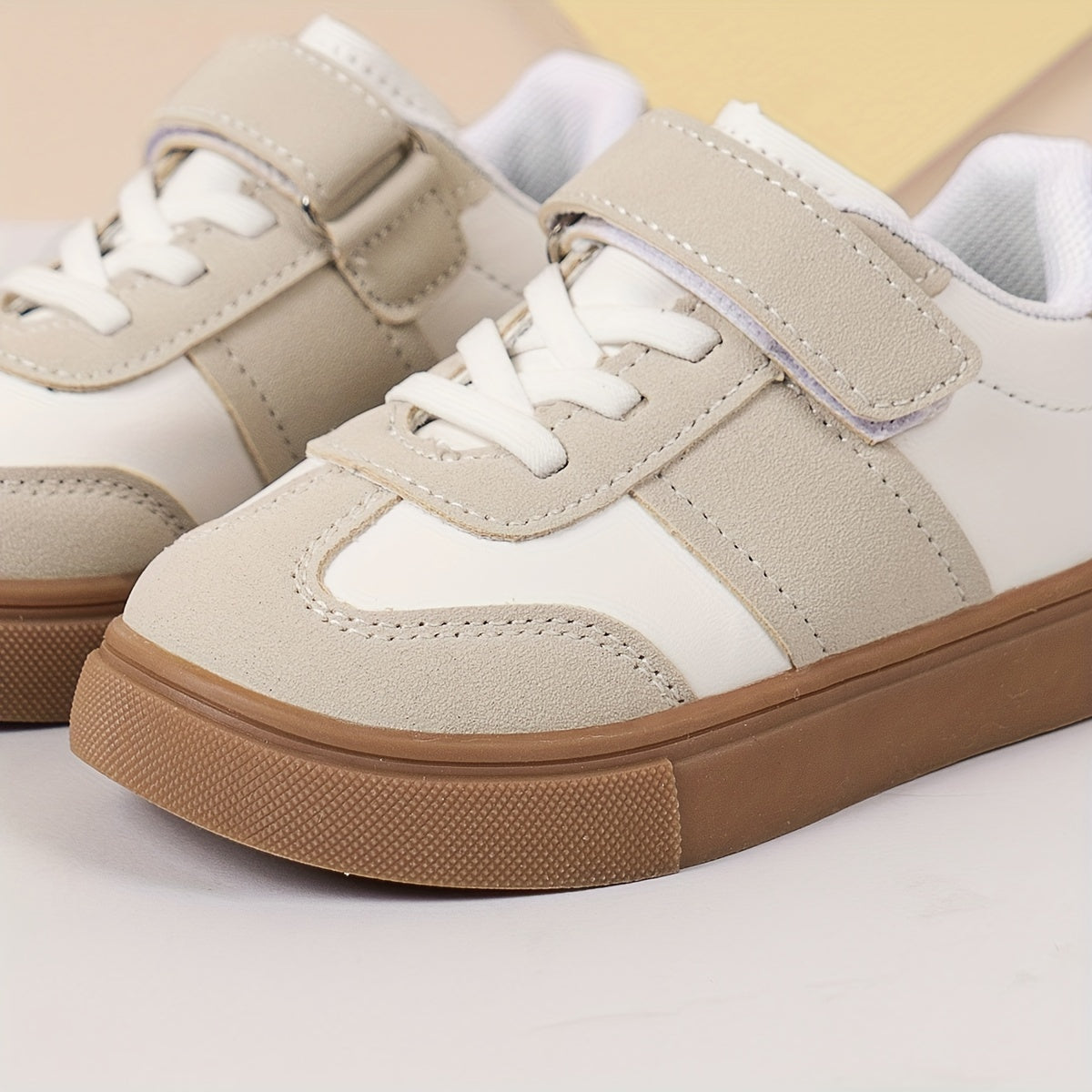 Youth sneakers with hook & loop fastener and non-slip sole, solid color design for boys and girls.