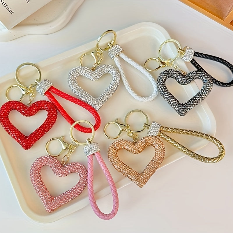 Heart-shaped resin keychain adorned with sparkling rhinestones, featuring a fun cartoon design for a touch of whimsy. Complete with a lobster clasp for easy attachment, this unique keyring is perfect for adding a festive touch to your holiday decor.