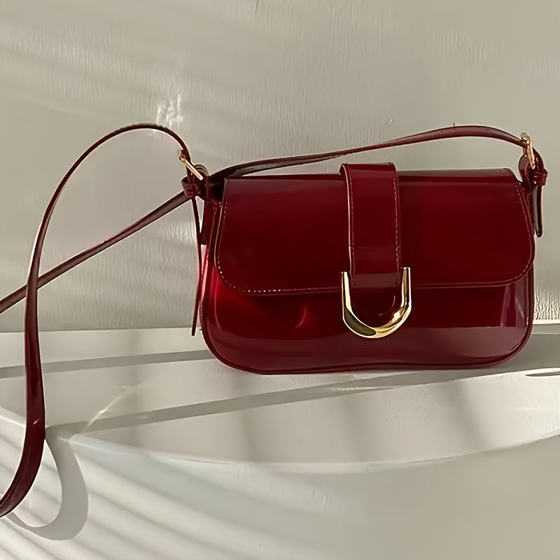 Elegant red baguette bag for women with detachable strap, golden-tone hardware, and glossy finish.