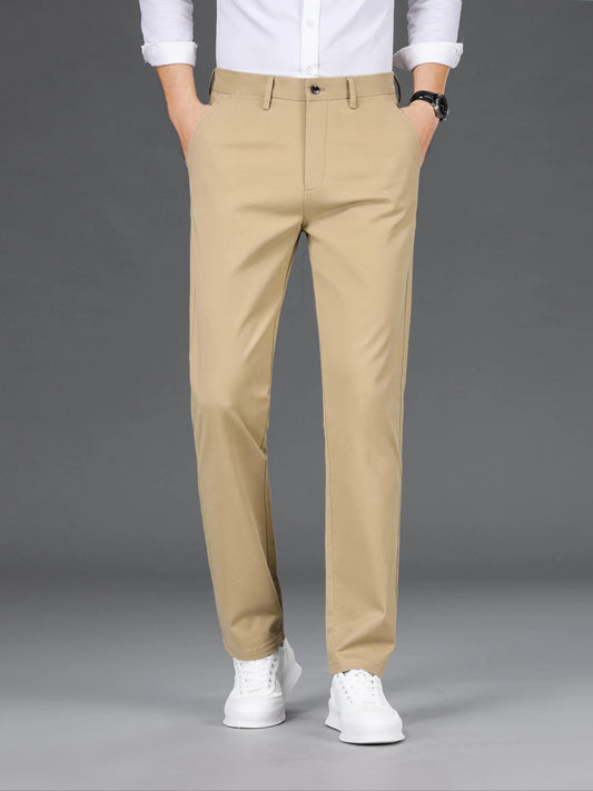 Men's slim-fit cotton blend trousers in solid color, suitable for business casual wear throughout the year. Features micro-elastic fabric, pockets, and regular length.