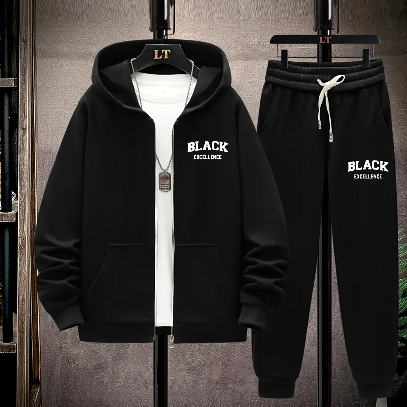 Polyester knit tracksuit set with black alphabet print and metal chain detail, ideal for fall/winter. Features slight stretch for a comfortable fit.